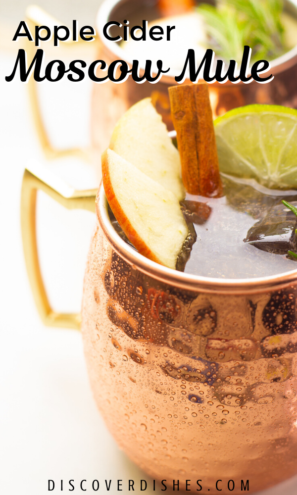 A close up of an apple cider moscow mule with text that reads "apple cider moscow mule".